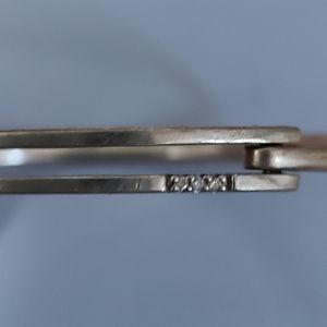 Sterling silver, stamped 925 , bracelet with claw hook. Three tiny diamonds